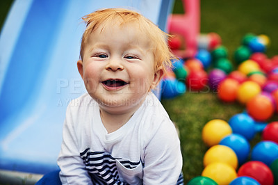 Buy stock photo Shot of an adorable little boy playing in the backyard