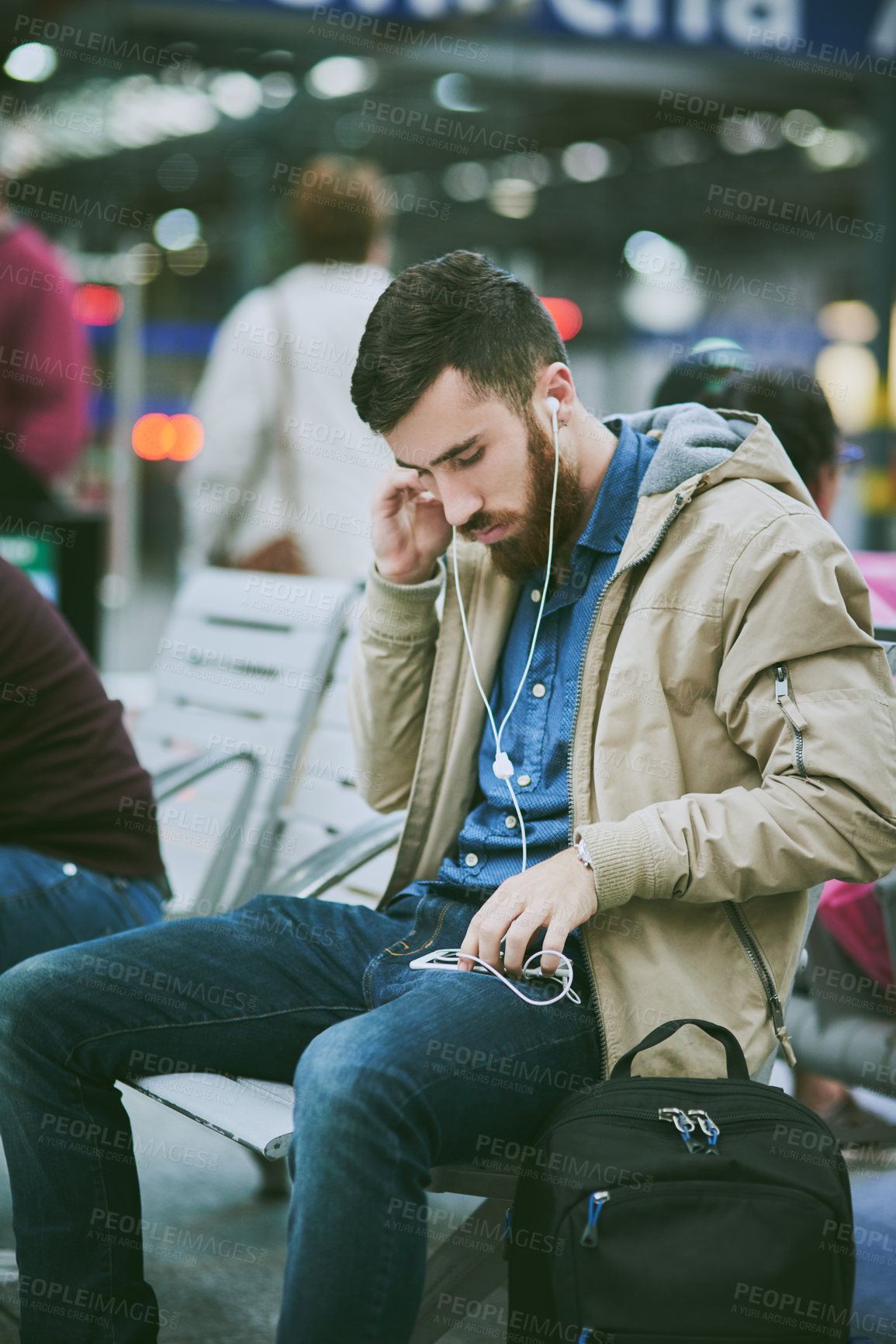 Buy stock photo Travel, earphones and man with phone at airport for music, streaming subscription and radio. International trip, commute and person waiting on smartphone for listening to song, audio and podcast