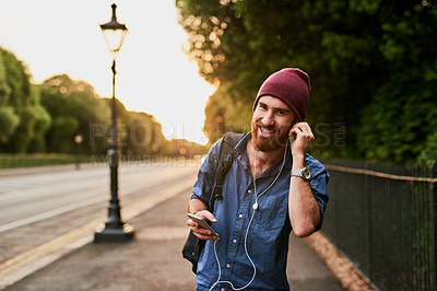 Buy stock photo Travel, walking and portrait of man in city for music, streaming subscription and online radio. Urban town, happy and person on smartphone with earphones for listening to song, audio and podcast