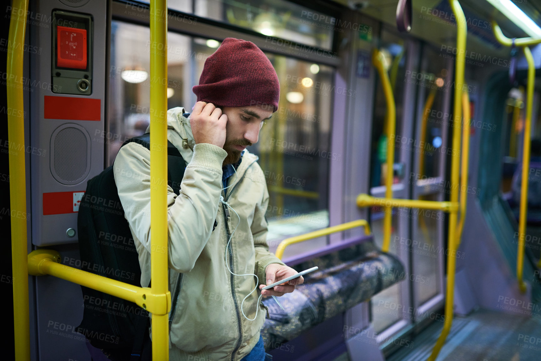 Buy stock photo Man, online and phone for music on bus journey, travel and social media scroll on public transport. Male person, streaming and earphones in metro vehicle, New York traveler and trip in urban traffic