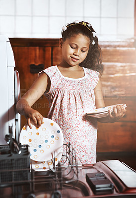 Buy stock photo Shot of an adorable little girl using a dishwashing machine at home