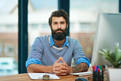 Buy stock photo Portrait, creative and confident businessman at desk in office by computer in startup company. Face, serious professional or entrepreneur, employee or copywriter working at table in Spain for career