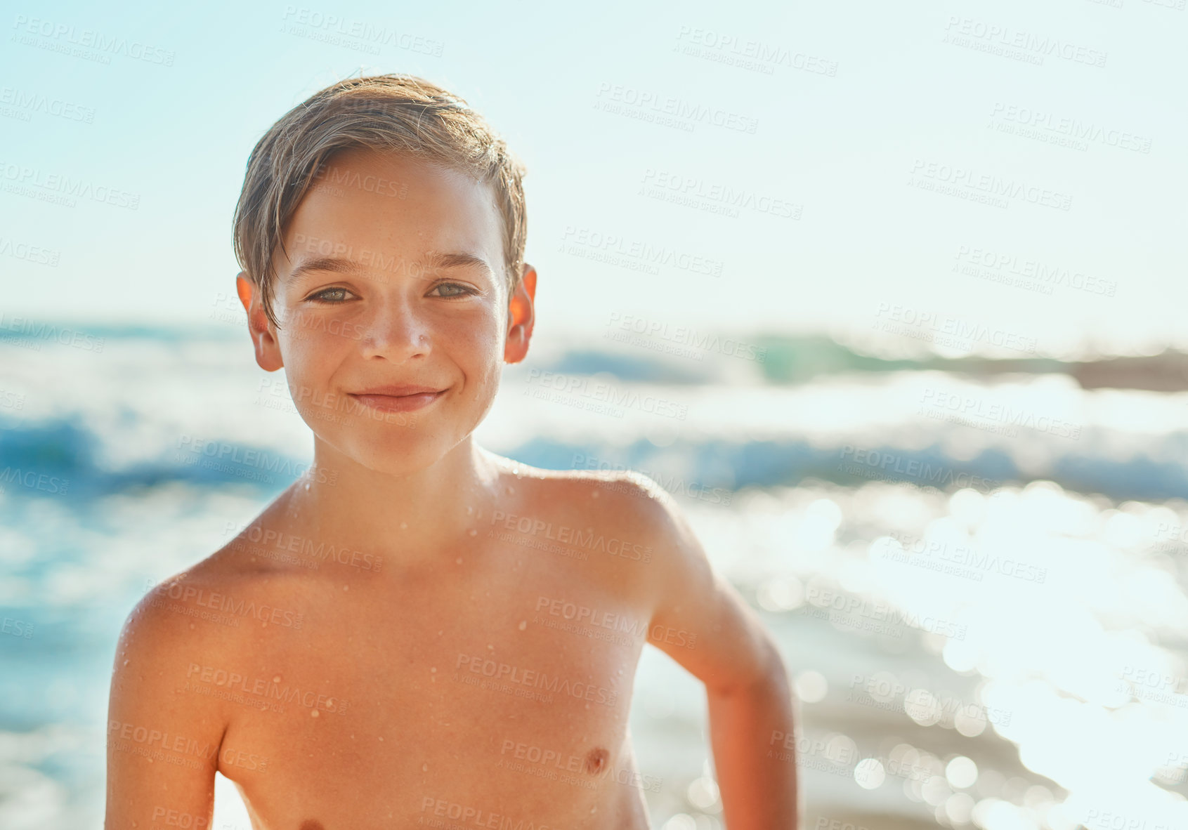 Buy stock photo Cropped shot of a young boy enjoying a day at the beach