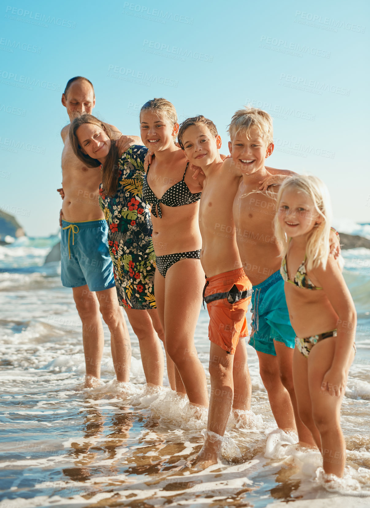 Buy stock photo Shot of a family of six spending the day at the beach