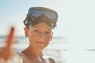 Buy stock photo Cropped shot of a young boy enjoying a day at the beach