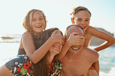 Buy stock photo Cropped shot of a couple and their two kids spending the day at the beach