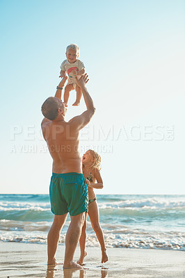 Buy stock photo Rearview shot of a man spending time with his son and daughter at the beach