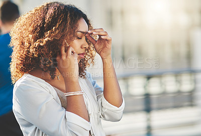 Buy stock photo Cropped shot of an attractive young woman looking stressed while making a phone call outside