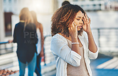 Buy stock photo Cropped shot of an attractive young woman looking stressed while making a phone call outside