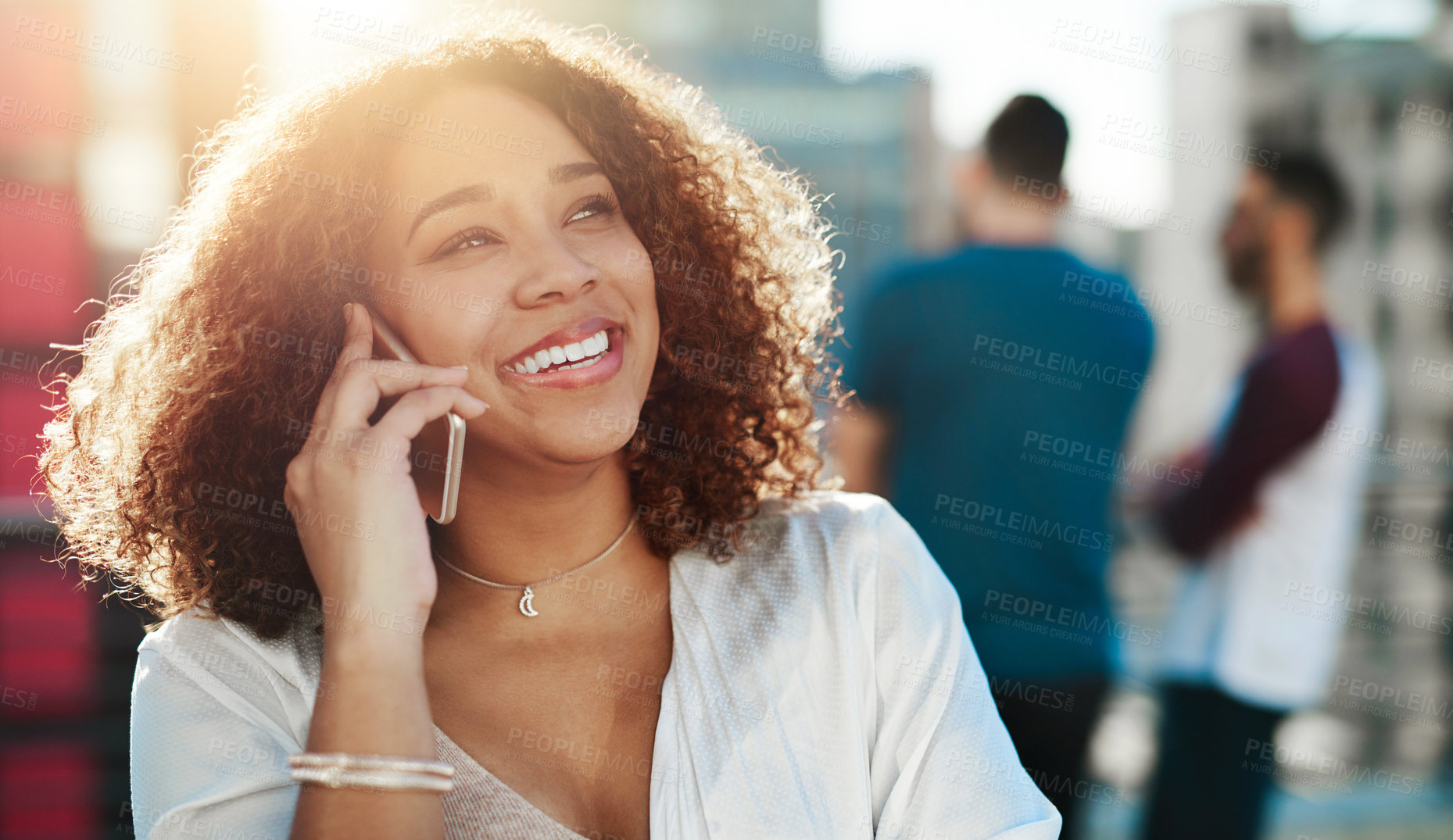 Buy stock photo Cropped shot of an attractive young woman making a phone call while standing outside