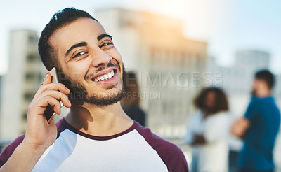 Buy stock photo Cropped portrait of a handsome young man making a phone call while standing outside