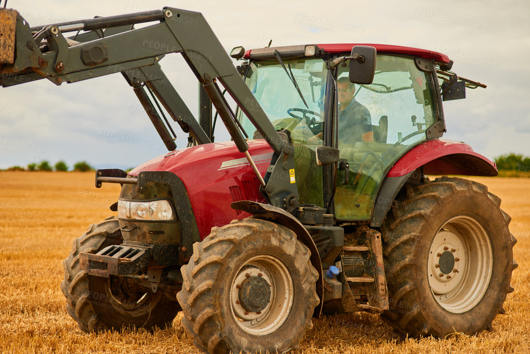 Buy stock photo Farming, man and tractor in land for care, ground maintenance and hay in countryside. Person, harvest machine and driving on California field for gathering, animal feed and agriculture in USA