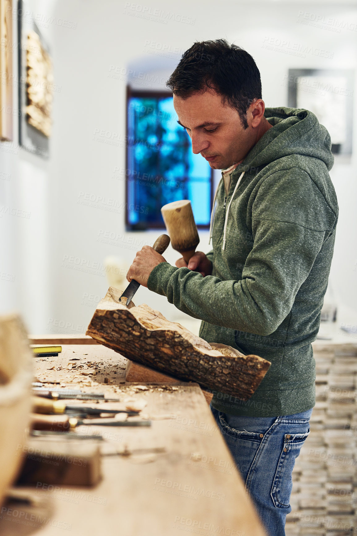 Buy stock photo Cropped shot of an artist carving something out of wood