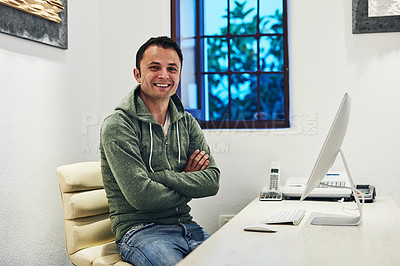 Buy stock photo Shot of a man sitting behind his computer in his office