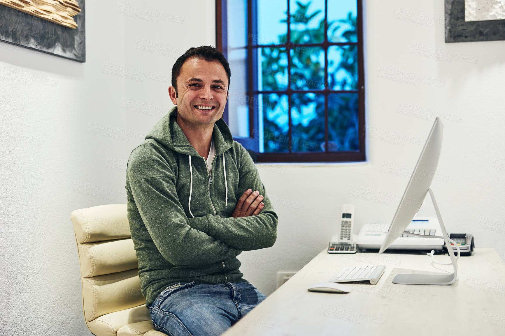 Buy stock photo Shot of a man sitting behind his computer in his office