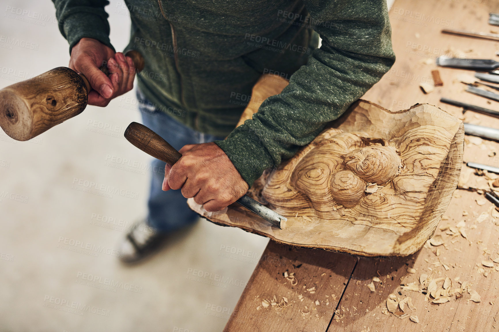 Buy stock photo Cropped shot of an artist carving something out of wood