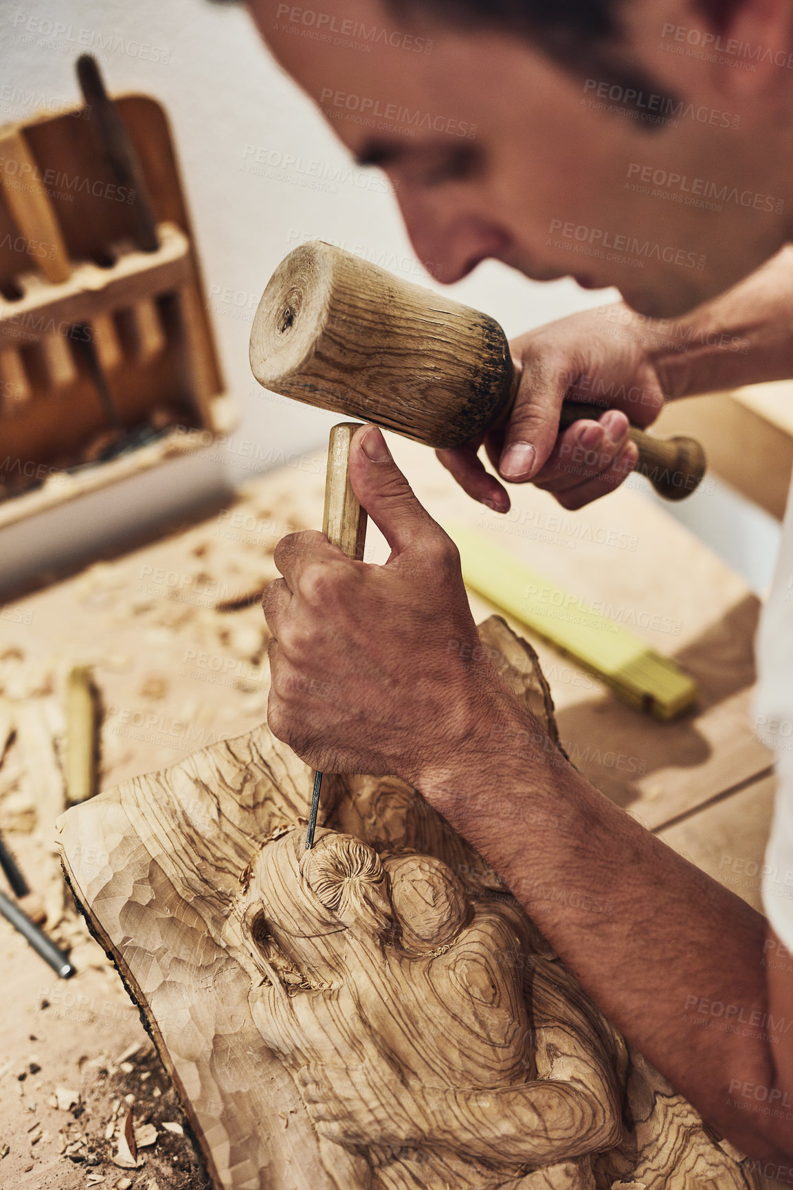 Buy stock photo Cropped shot of an artist carving something out of wood