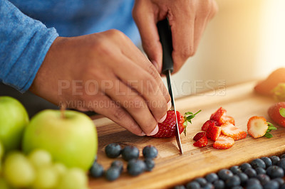 Buy stock photo Cropped shot of an unrecognizable man preparing a healthy and fruity snack