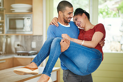 Buy stock photo Cropped shot of a handsome young man lovingly carrying his wife through their home