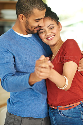 Buy stock photo Cropped shot of an affectionate young couple dancing together at home