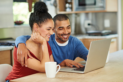 Buy stock photo Cropped shot of an affectionate young couple using a laptop together at home