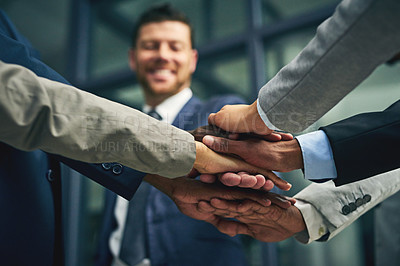 Buy stock photo Closeup shot of a group of unidentifiable businesspeople joining their hands together in unity