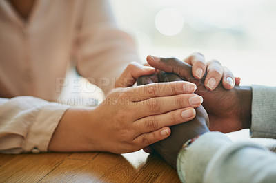 Buy stock photo Comfort, kindness and forgiveness with a biracial couple holding hands, united in support in a crisis. Caring wife showing love to her depressed husband with a gentle gesture of affection