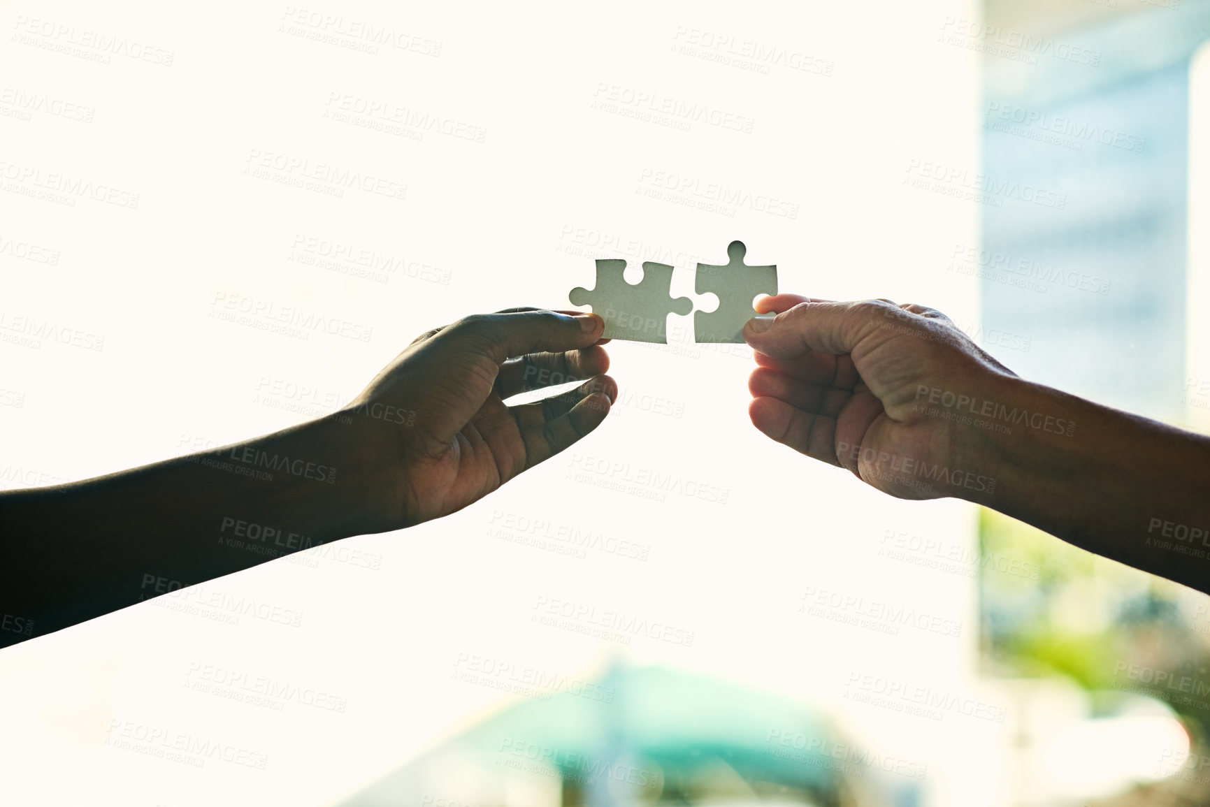 Buy stock photo Closeup shot of two unidentifiable people holding puzzle pieces together
