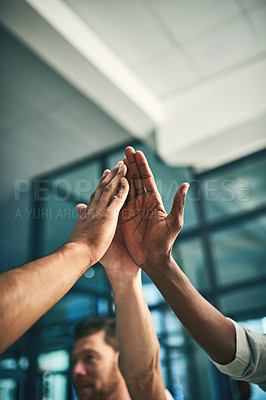 Buy stock photo Closeup shot of a group of unidentifiable businesspeople high fiving in an office