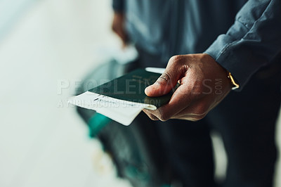 Buy stock photo Shot of an unrecognizable person holding his passport indoors