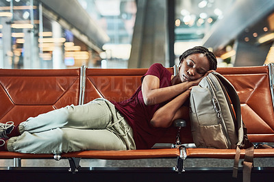 Buy stock photo Shot of a young woman falling asleep at the airport while waiting for departure