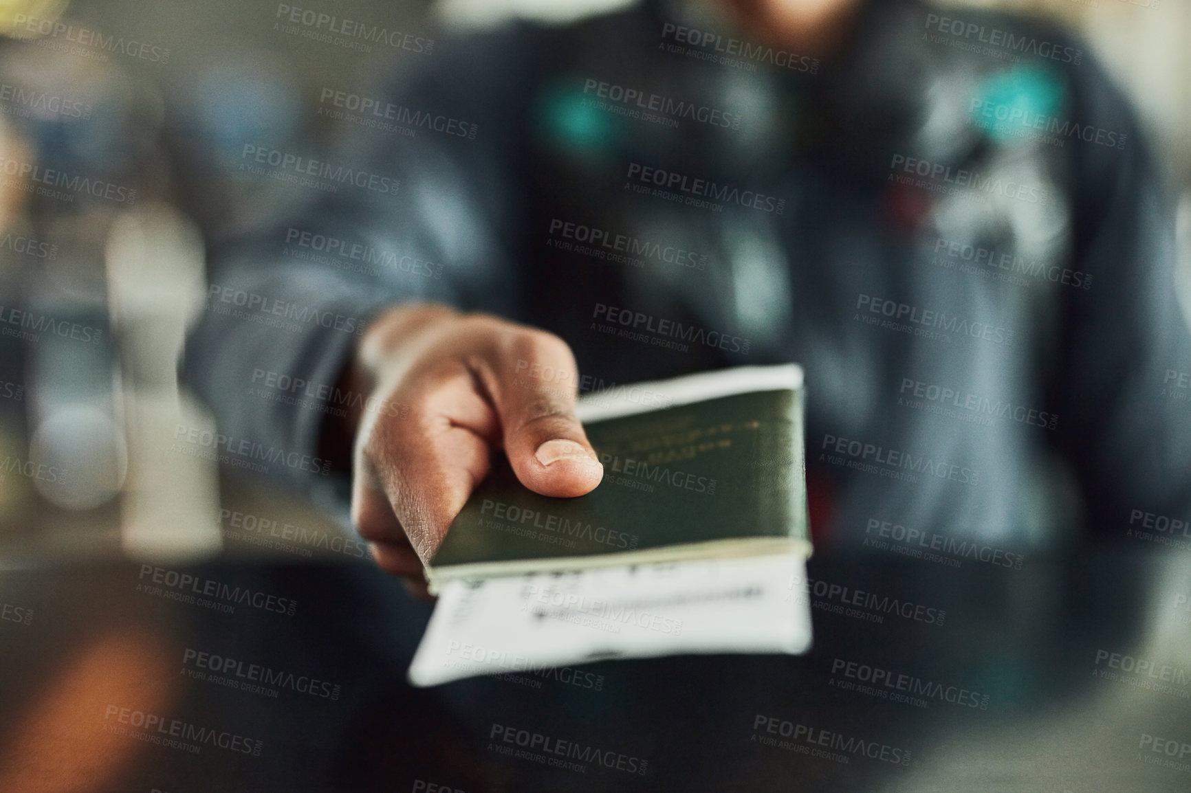 Buy stock photo Shot of an unrecognizable person holding his passport indoors