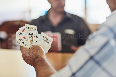 Buy stock photo Cropped shot of seniors playing poker in their retirement home