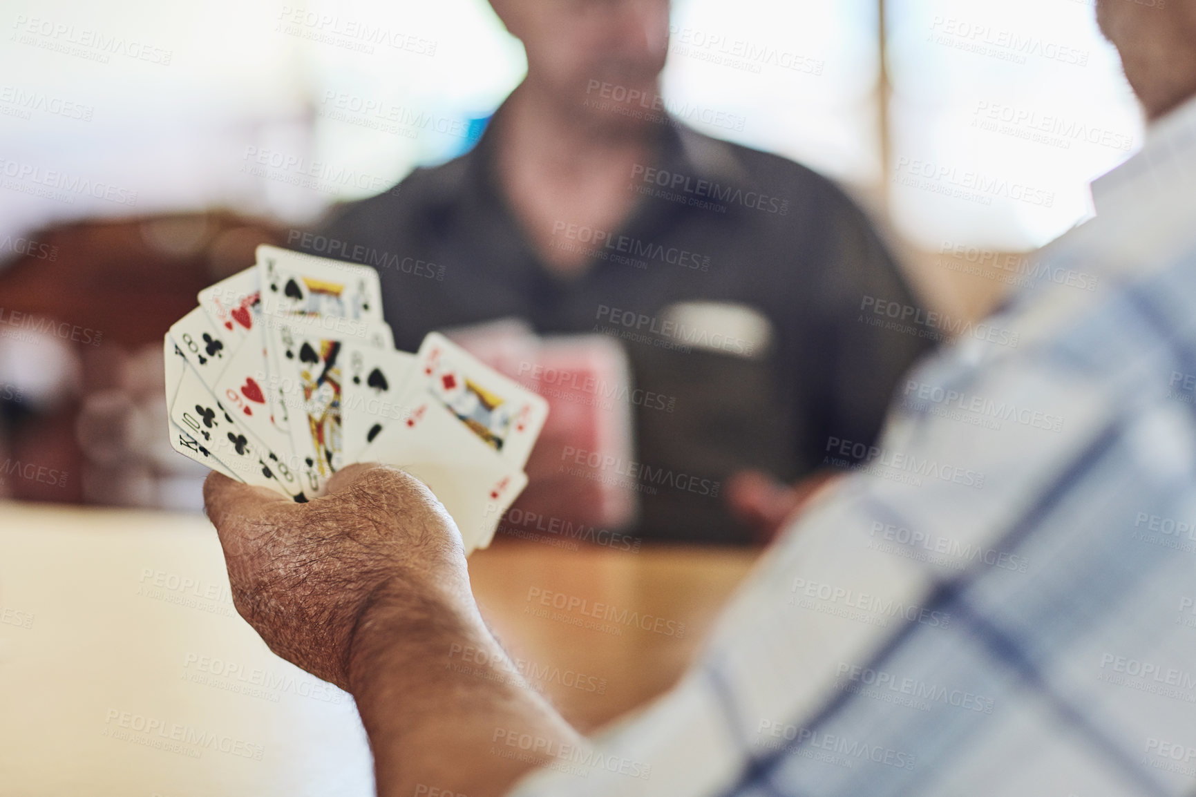 Buy stock photo Cropped shot of seniors playing poker in their retirement home