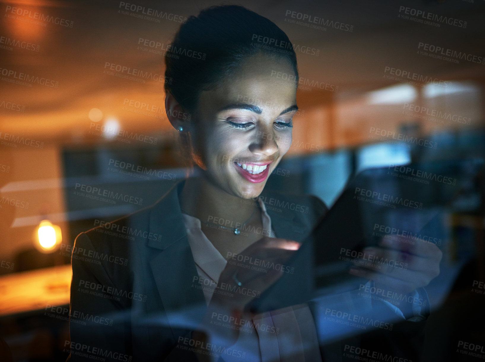 Buy stock photo Shot of a young businesswoman using a tablet in the office at night 