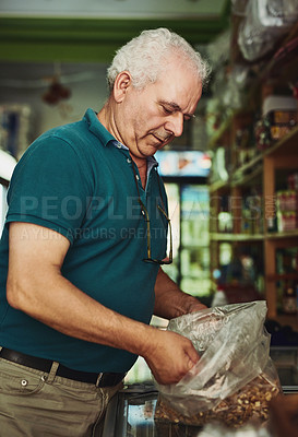Buy stock photo Shot of a senior man working in a store