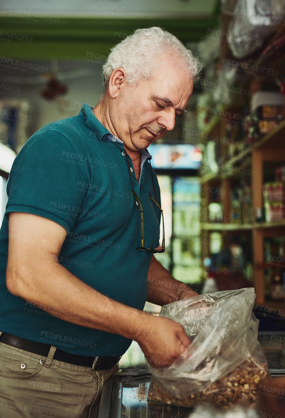 Buy stock photo Shot of a senior man working in a store