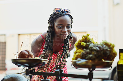 Buy stock photo Shot of a woman peering through a shop's window while out on a shopping spree