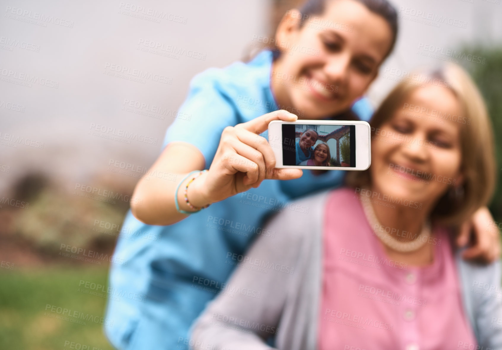 Buy stock photo Cropped shot of a caregiver taking a selfie with a senior patient outside