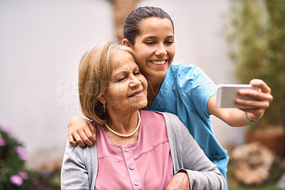 Buy stock photo Cropped shot of a caregiver taking a selfie with a senior patient outside