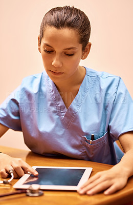 Buy stock photo Cropped shot of a female nurse using a digital tablet