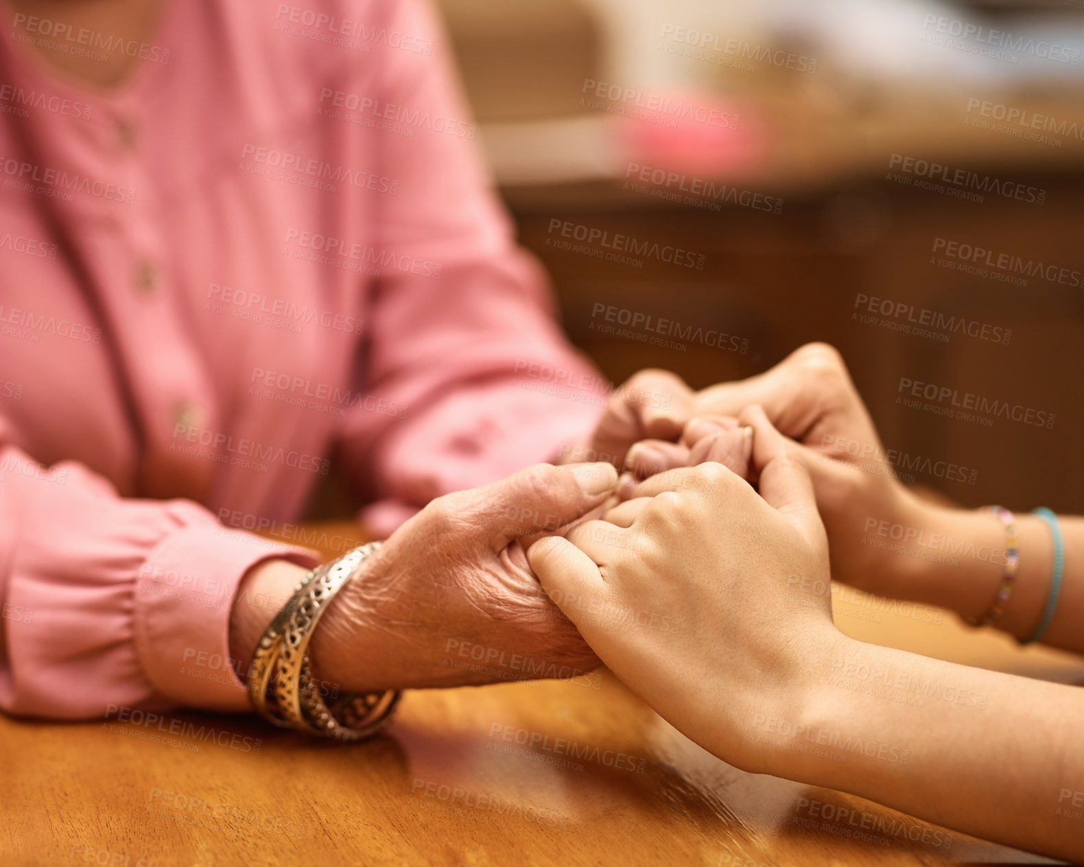 Buy stock photo People, holding hands and support in nursing home for help, empathy or hope in living room. Person, woman or senior care at wooden table for grief counselling, trust or mental health in retirement