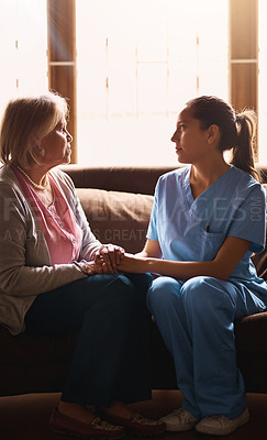 Buy stock photo Shot of a nurse holding a senior woman's hands in comfort