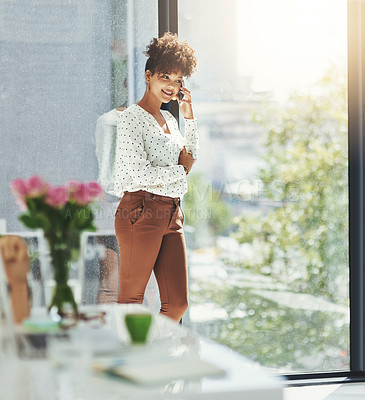 Buy stock photo Shot of a young businesswoman talking on her cellphone