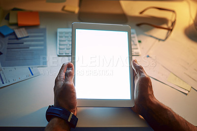 Buy stock photo Cropped shot of an unrecognizable man using a digital tablet during a late night at work
