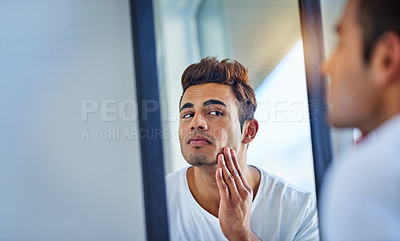 Buy stock photo Skincare, man looking in a mirror and face in bathroom with lens flare. Body treatment or cosmetics for wellness, dermatology or skin routine and facial care with male person at home in morning
