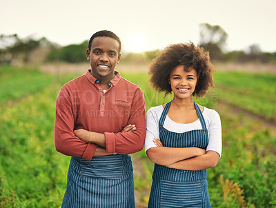 Buy stock photo Cropped portrait of a young farm couple standing with their arms folded