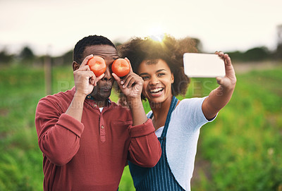 Buy stock photo Cropped shot of an affectionate young couple taking selfies while working on their farm