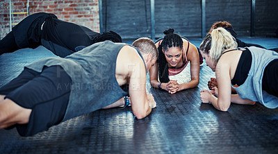 Buy stock photo Shot of a fitness group having a workout session at the gym