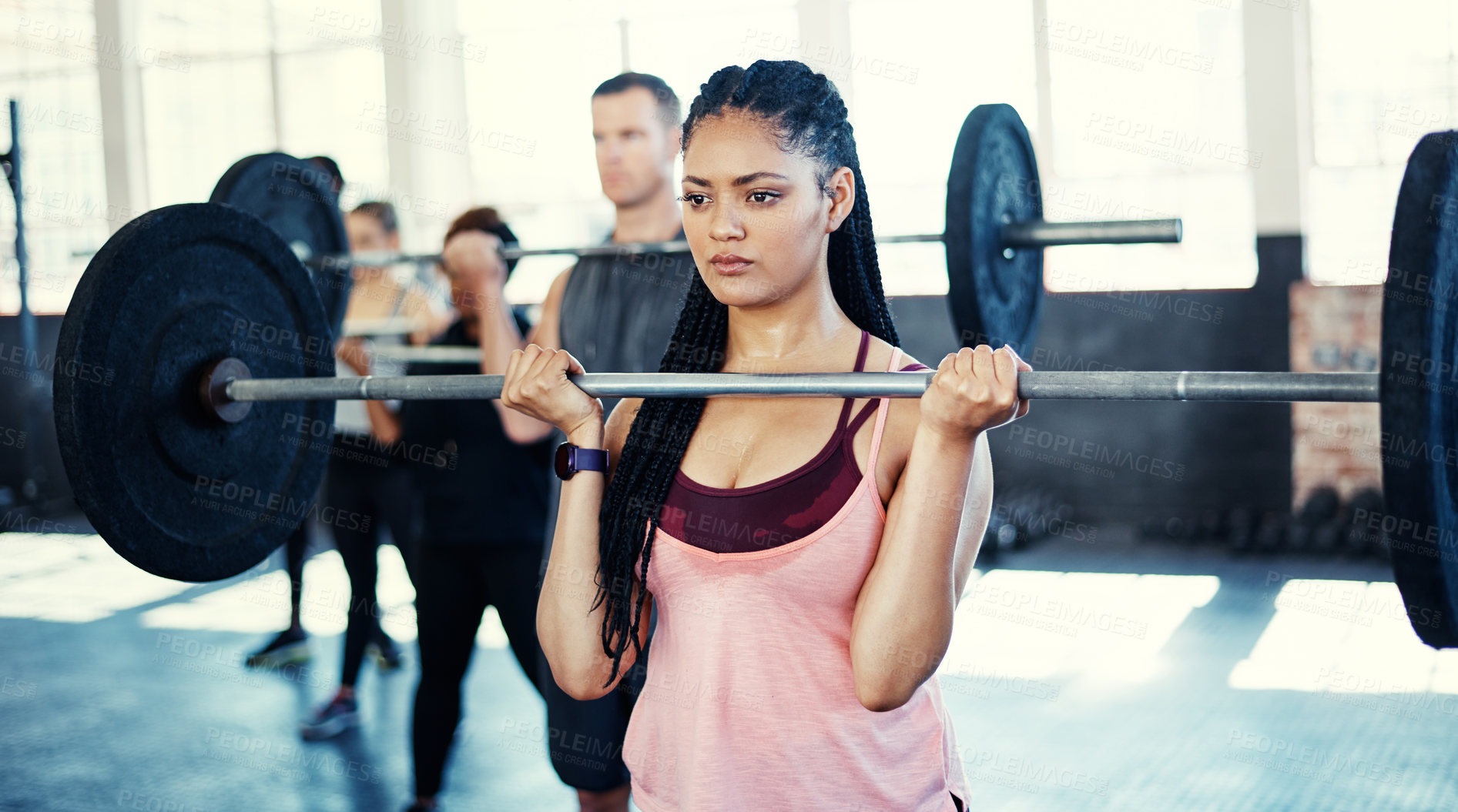 Buy stock photo Shot of a woman working out with a barbell in her session at the gym